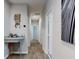 Hallway with wood floors, white trim and walls, and decoratively appointed nook at 727 Porter Rye Ave, Debary, FL 32713