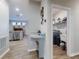 Hallway view of kitchen, breakfast nook, and laundry room with sink at 727 Porter Rye Ave, Debary, FL 32713