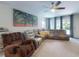 Spacious living room with carpet flooring, ceiling fan, and large three piece tree artwork at 727 Porter Rye Ave, Debary, FL 32713