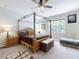 Bright main bedroom with canopy bed, ceiling fan, multiple windows, and sitting bench at 727 Porter Rye Ave, Debary, FL 32713