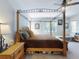 Bright main bedroom with canopy bed, ceiling fan, and multiple windows at 727 Porter Rye Ave, Debary, FL 32713