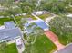 Aerial shot of a landscaped home with a screen enclosed pool in a neighborhood with mature trees at 805 E 15Th Ave, New Smyrna Beach, FL 32169