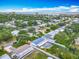 Charming aerial view showcasing homes with a community pool, lush greenery, and close proximity to the ocean at 805 E 15Th Ave, New Smyrna Beach, FL 32169
