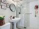 Bathroom featuring updated tile shower, new toilet, sink, stylish mirror and modern fixtures at 805 E 15Th Ave, New Smyrna Beach, FL 32169