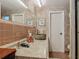 Bathroom features a unique vessel sink, granite countertop, and framed mirror at 805 E 15Th Ave, New Smyrna Beach, FL 32169