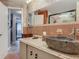 Bathroom featuring a unique vessel sink, granite countertop, and framed mirror at 805 E 15Th Ave, New Smyrna Beach, FL 32169