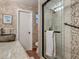 Bathroom features granite countertop, mosaic tile walls, and glass shower enclosure at 805 E 15Th Ave, New Smyrna Beach, FL 32169