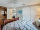 Bedroom featuring wood furnishings, neutral walls, ceiling fan and a double door closet at 805 E 15Th Ave, New Smyrna Beach, FL 32169