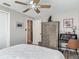 Neutral bedroom with ceiling fan, a wardrobe, and a desk area with decor at 805 E 15Th Ave, New Smyrna Beach, FL 32169