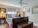 Charming bedroom with rustic accents, warm lighting, wooden chest, and colorful rug at 805 E 15Th Ave, New Smyrna Beach, FL 32169
