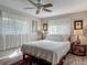 Bright bedroom featuring a large window and a white quilt bed set at 805 E 15Th Ave, New Smyrna Beach, FL 32169