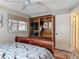 Bedroom featuring wood furnishings, neutral walls, ceiling fan and a window overlooking the neighborhood at 805 E 15Th Ave, New Smyrna Beach, FL 32169