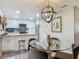 Cozy dining area featuring a modern light fixture and views of the kitchen at 805 E 15Th Ave, New Smyrna Beach, FL 32169