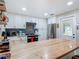 Well-equipped kitchen with butcher block countertops, white cabinets, and stainless steel appliances at 805 E 15Th Ave, New Smyrna Beach, FL 32169