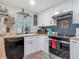 Updated kitchen showcasing white cabinetry, dark backsplash, and modern appliances at 805 E 15Th Ave, New Smyrna Beach, FL 32169