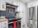 Modern kitchen features stainless steel appliances, blue backsplash, and light wood countertops at 805 E 15Th Ave, New Smyrna Beach, FL 32169
