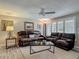 Comfortable living room with hardwood floors, a ceiling fan, and plush seating furniture at 805 E 15Th Ave, New Smyrna Beach, FL 32169