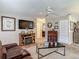 Bright living room with a ceiling fan, fireplace, and neutral-toned walls at 805 E 15Th Ave, New Smyrna Beach, FL 32169