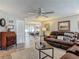 Comfortable living room with hardwood floors, plush seating furniture, and adjoined dining area at 805 E 15Th Ave, New Smyrna Beach, FL 32169