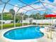 Inviting screened pool with clear blue water, seating area, and well-maintained landscaping at 805 E 15Th Ave, New Smyrna Beach, FL 32169