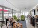 Bright sunroom with lots of natural light, comfortable seating, and access to the backyard at 805 E 15Th Ave, New Smyrna Beach, FL 32169