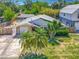 Aerial shot of home showcasing landscaping, an attached garage and proximity to a screened-in pool at 830 Christy Dr, Port Orange, FL 32129