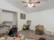 An ample bedroom showcasing gray flooring, a ceiling fan, and a closet at 830 Christy Dr, Port Orange, FL 32129