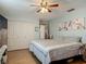 Comfortable bedroom with a ceiling fan, large closet, and soft, relaxing decor for a peaceful retreat at 830 Christy Dr, Port Orange, FL 32129