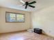Bright bedroom featuring a window with natural light and neutral walls complemented by wood-look flooring at 830 Christy Dr, Port Orange, FL 32129