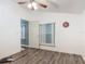 Well lit bedroom features a fan, a window, laminate floor and an open doorway leading to another room at 830 Christy Dr, Port Orange, FL 32129