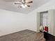 A minimalist bedroom includes an updated ceiling fan, closet, and modern laminate flooring at 830 Christy Dr, Port Orange, FL 32129