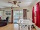 Bright dining area with a white table set, ceiling fan, natural light and access to the outdoors at 830 Christy Dr, Port Orange, FL 32129