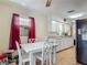Cozy dining area with a view, featuring a white table set and natural lighting at 830 Christy Dr, Port Orange, FL 32129