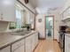 Kitchen featuring a double sink, tiled countertops and an adjacent bathroom at 830 Christy Dr, Port Orange, FL 32129