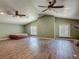 Spacious living room with vaulted ceilings, dual ceiling fans, and natural light creates an open atmosphere at 830 Christy Dr, Port Orange, FL 32129