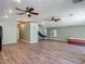 Open living area features hardwood floors, ceiling fans and ample space, perfect for entertaining or relaxation at 830 Christy Dr, Port Orange, FL 32129