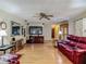 Bright living room featuring a ceiling fan and hardwood floors that flow into other living spaces at 830 Christy Dr, Port Orange, FL 32129