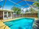 Sparkling screened-in pool with patio area, perfect for relaxation at 830 Christy Dr, Port Orange, FL 32129
