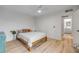 Serene bedroom featuring wood floors, a comfortable bed, and an attached bathroom for added privacy at 90 Cedar Dunes Dr, New Smyrna Beach, FL 32169