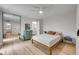 Cozy bedroom with hardwood floors, mirrored closet, and a view into the ensuite bathroom at 90 Cedar Dunes Dr, New Smyrna Beach, FL 32169