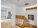 Upstairs hallway featuring wood floors, artistic accents, and access to bedrooms and other living spaces at 90 Cedar Dunes Dr, New Smyrna Beach, FL 32169