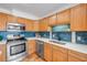 Close up of a modern kitchen, featuring stainless steel appliances, quartz countertop, and stylish blue tile backsplash at 90 Cedar Dunes Dr, New Smyrna Beach, FL 32169