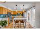 Bright kitchen featuring stainless steel appliances, tile backsplash, island with seating, and Saltillo tile floor at 90 Cedar Dunes Dr, New Smyrna Beach, FL 32169