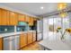 Bright kitchen featuring stainless steel appliances, tile backsplash, ample cabinetry, and sliding door access at 90 Cedar Dunes Dr, New Smyrna Beach, FL 32169