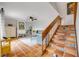 Bright living room with staircase to upper level, Saltillo tile floor, and comfortable furnishings at 90 Cedar Dunes Dr, New Smyrna Beach, FL 32169