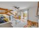 Bright living room with Saltillo tile floor, wood staircase, and sliding glass doors to the outdoor patio at 90 Cedar Dunes Dr, New Smyrna Beach, FL 32169
