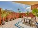 Inviting outdoor patio area with dining set, stylish rug, and lush landscaping for relaxing or entertaining at 90 Cedar Dunes Dr, New Smyrna Beach, FL 32169