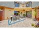 Outdoor patio area with a dining table and chairs, brick flooring, and a balcony view above the open space at 90 Cedar Dunes Dr, New Smyrna Beach, FL 32169