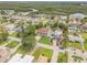 Lovely neighborhood aerial shot with a well-maintained lawn and mature trees at 90 Cunningham Dr, New Smyrna Beach, FL 32168