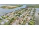Aerial view showcases a home near the waterfront with an easy ocean access in a serene neighborhood at 90 Cunningham Dr, New Smyrna Beach, FL 32168